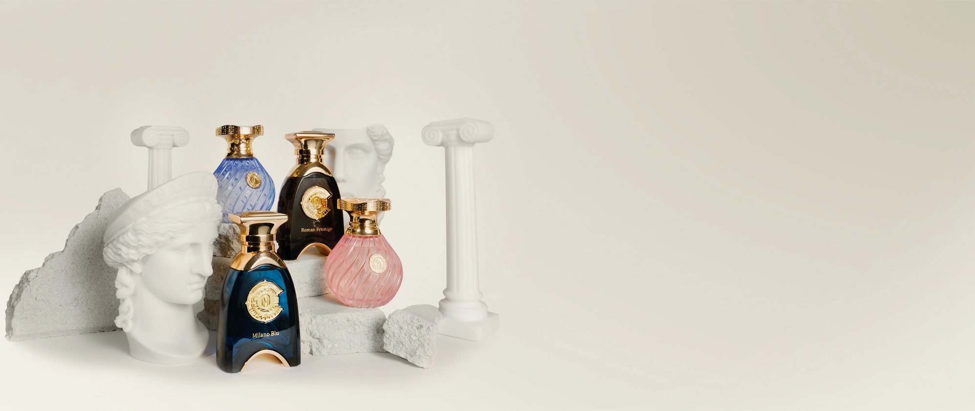 Assorted Marc Olivetti fragrances displayed on sculptural pedestals